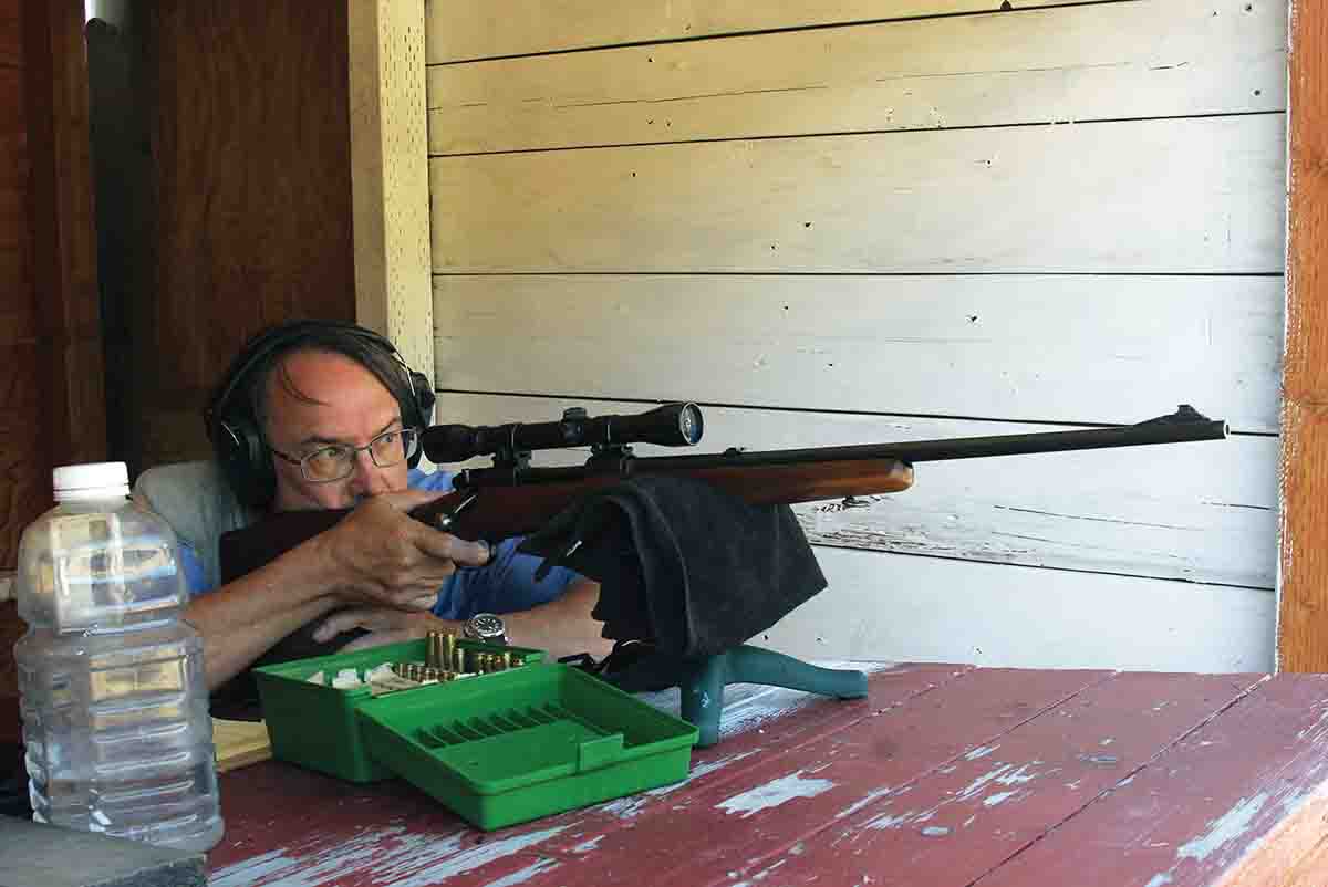 A .308 with an aluminum buttplate can sting during summer benchrest sessions, so John used a PAST pad on his right shoulder. The water bottle is for quickly cooling the barrel between groups.